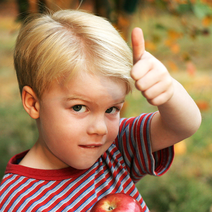 Child eating an apple as a healthy snack